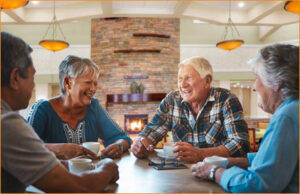 Four happy people around a table